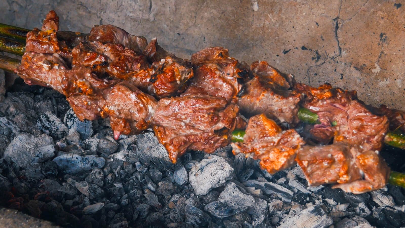 Traditional espetada skewers grilling during a Madeira cooking class