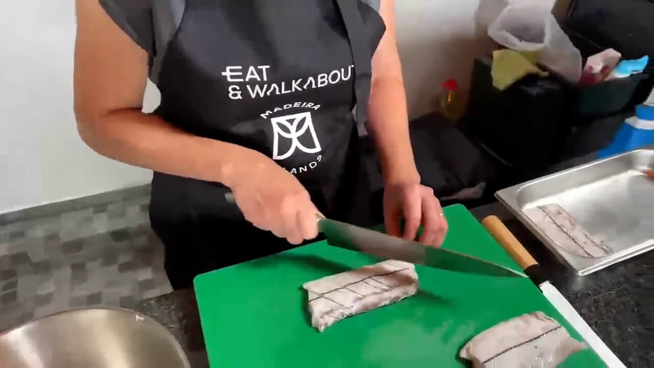 Black scabbardfish being prepared during a traditional Madeira cooking demonstration