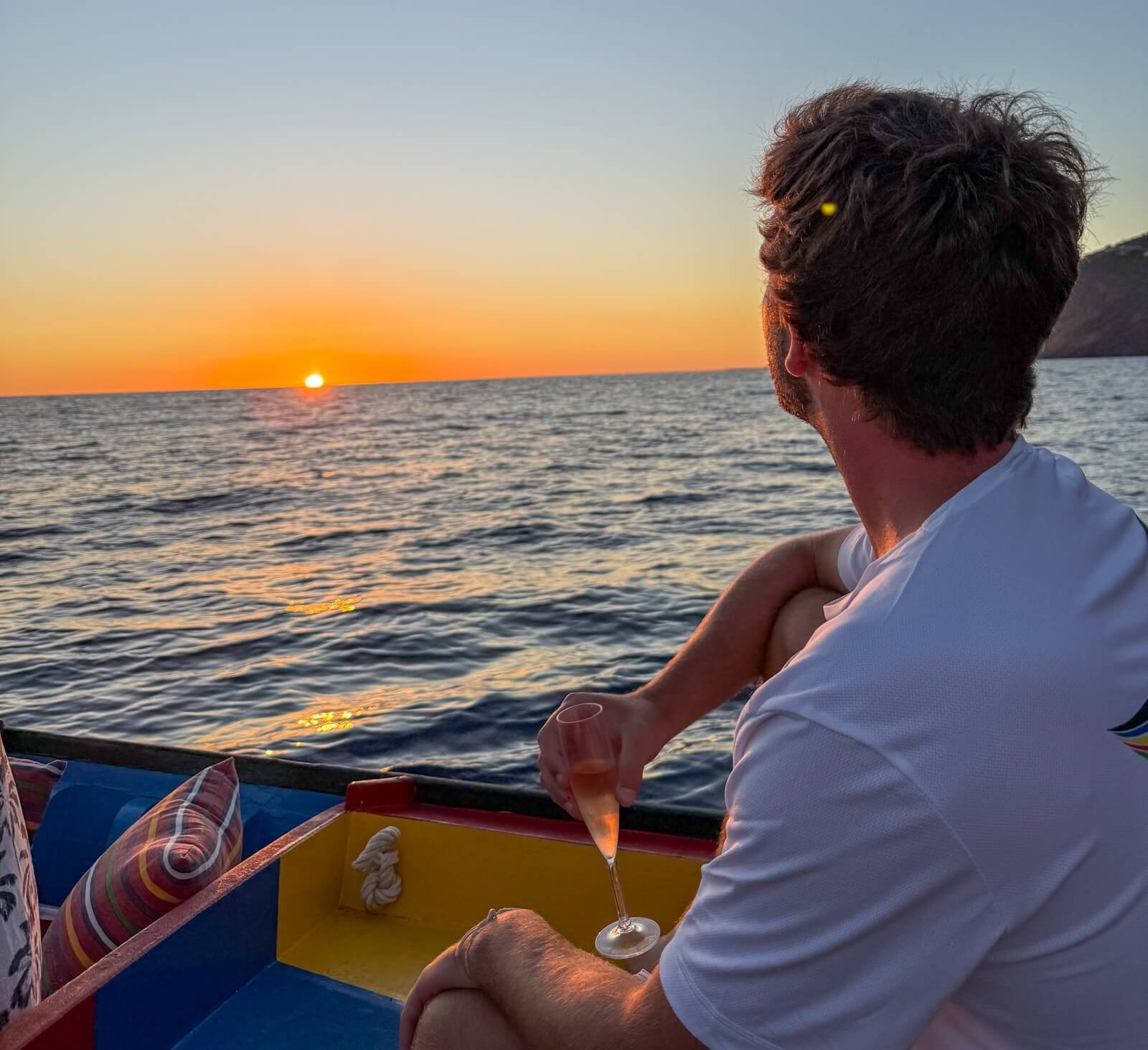 Guest enjoying a drink during a Madeira sunset boat tour from Funchal